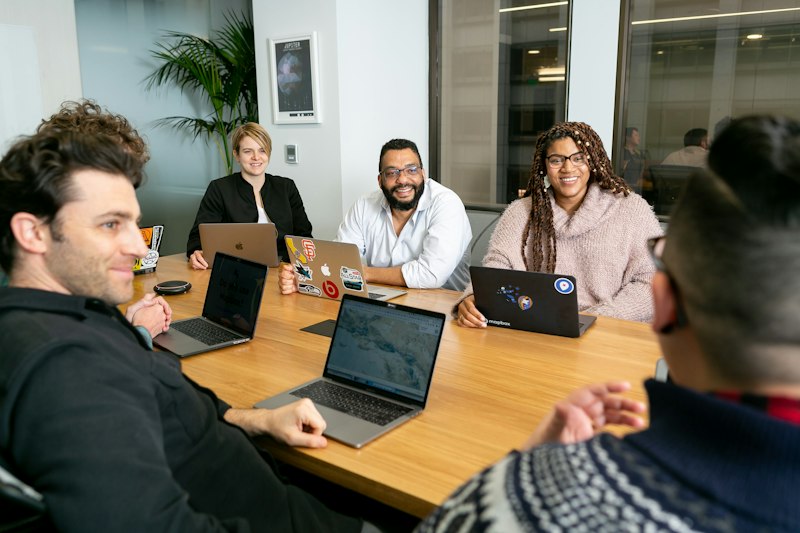 Small team working together on laptops around a table