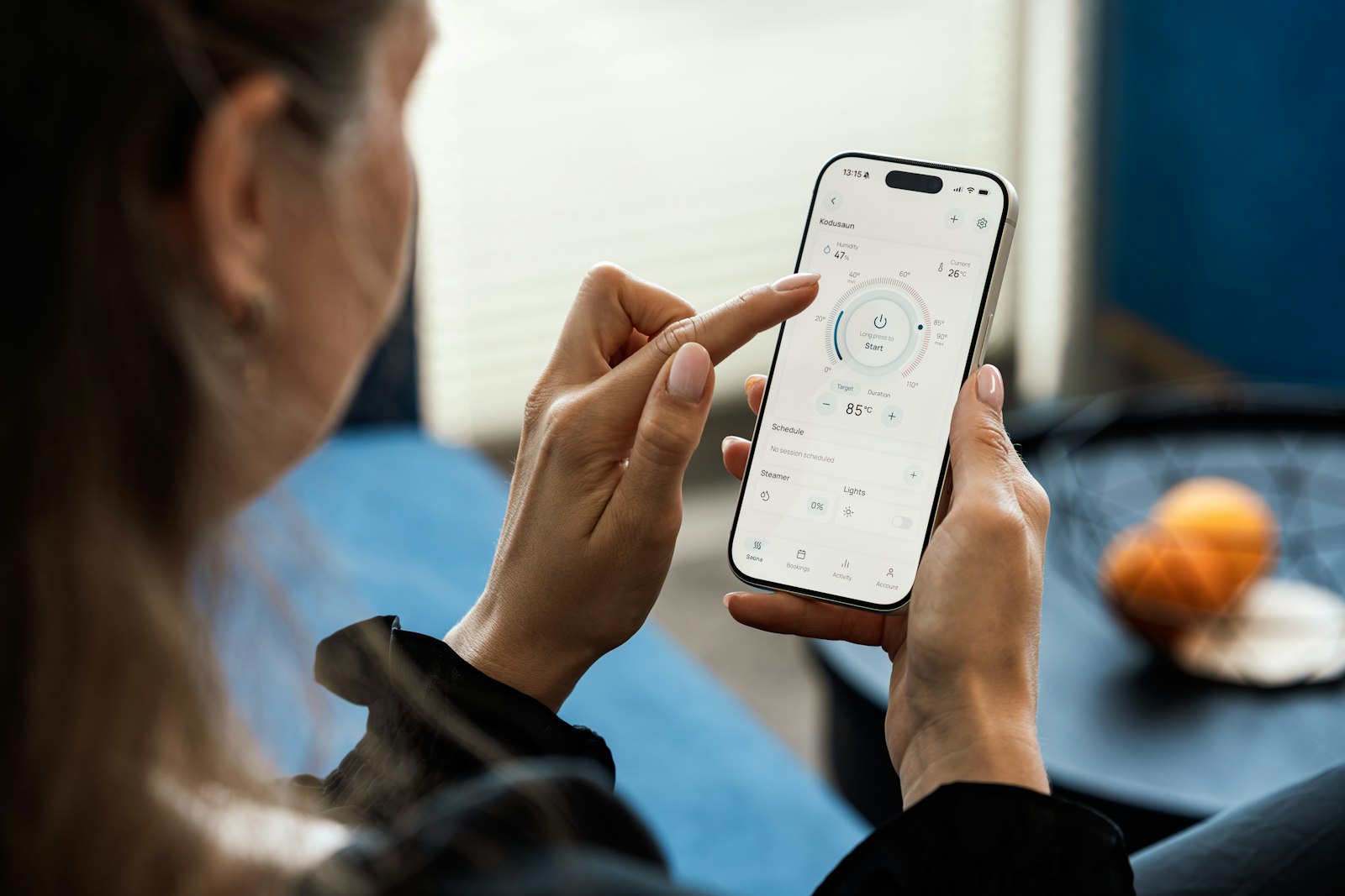 Person using a smart home app on a smartphone