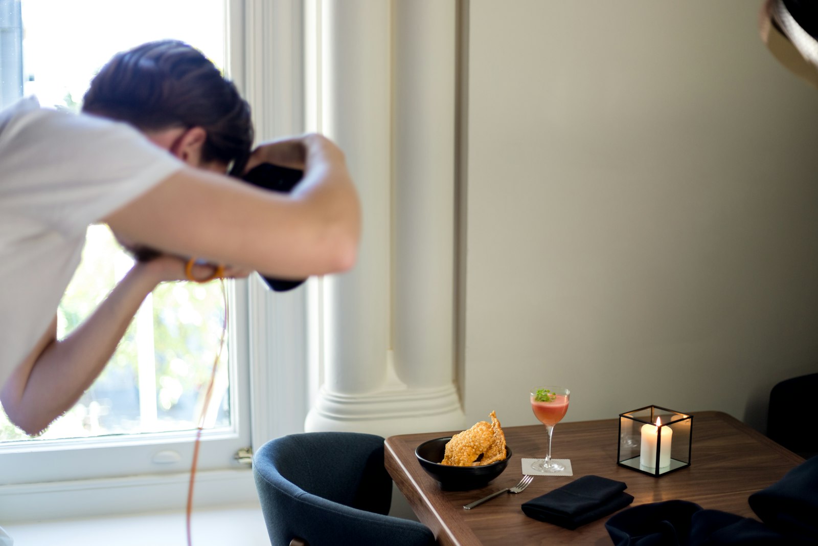 Photographer taking a picture of a styled dining table